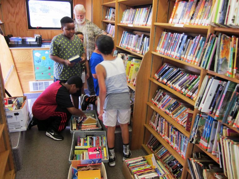 Kids choosing books inside the bookmobile