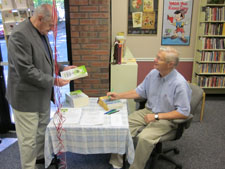 Man signing book at the Grand Opening 