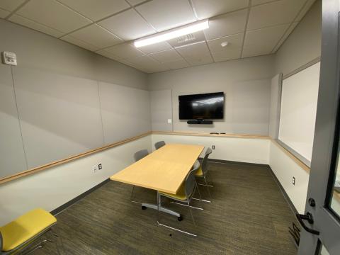 Small room with chairs, white board and AV screen